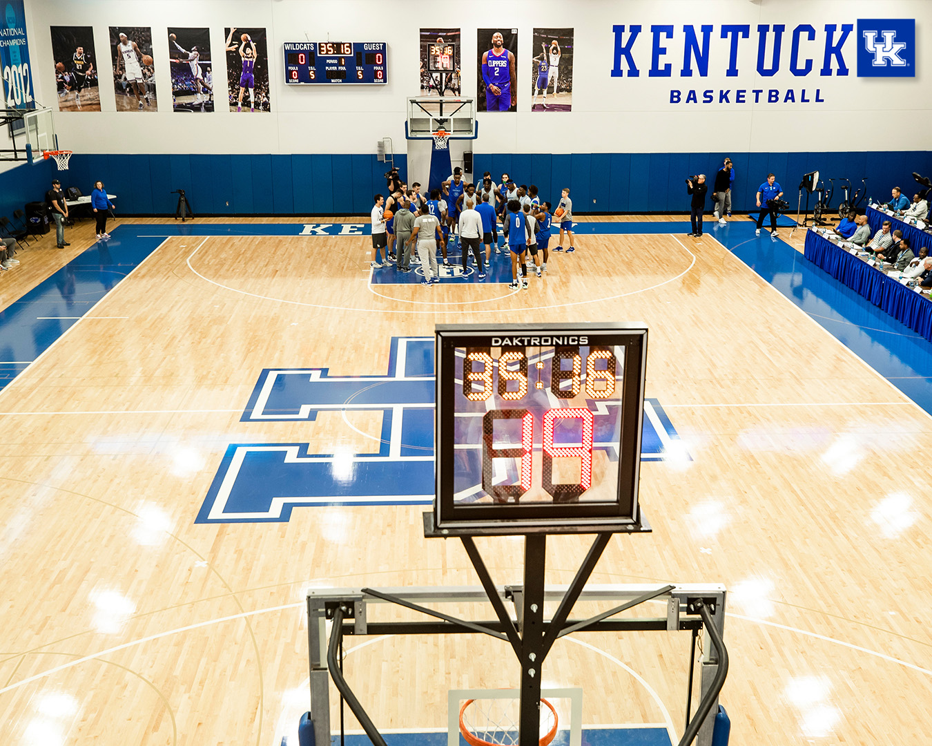 Team huddle takes place under the far basket.