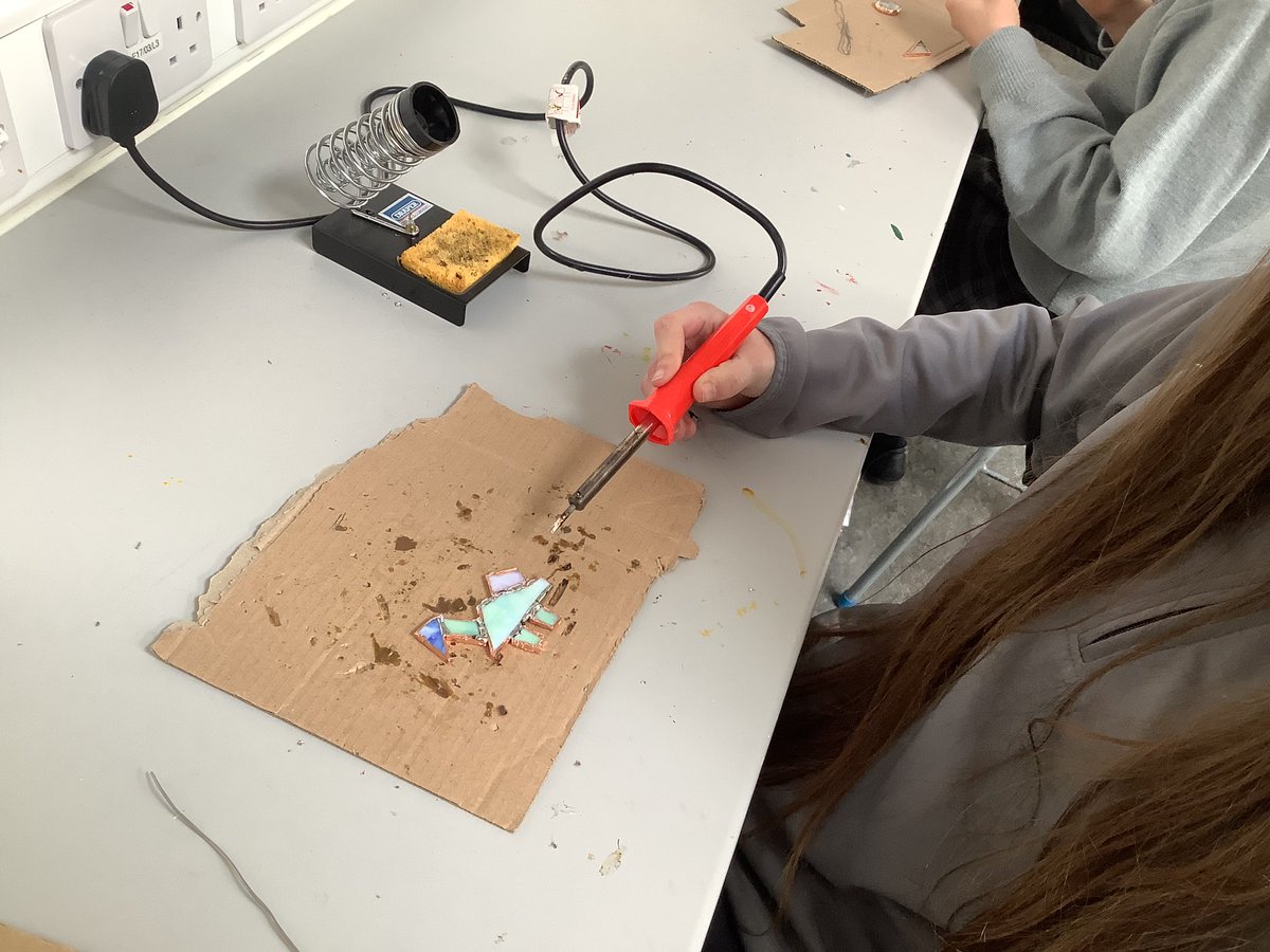 Oide_SarahMc's tweet photo. TYs nearly halfway through their Stained Glass module! Students are making a hanging decoration by cutting coloured glass, wrapping in copper tape and soldering together. #transitionyear #ddletb @Kingswoodcc16 https://t.co/LcK15VwLJp