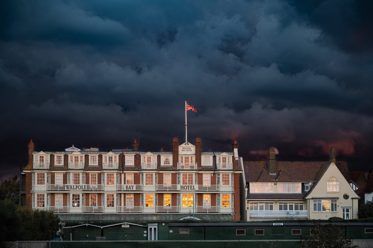 View of @WBH_WalpoleBay Hotel lit up by the setting sun while stormy clouds lurk in the east. #Margate #Cliftonville #Kent #thanet