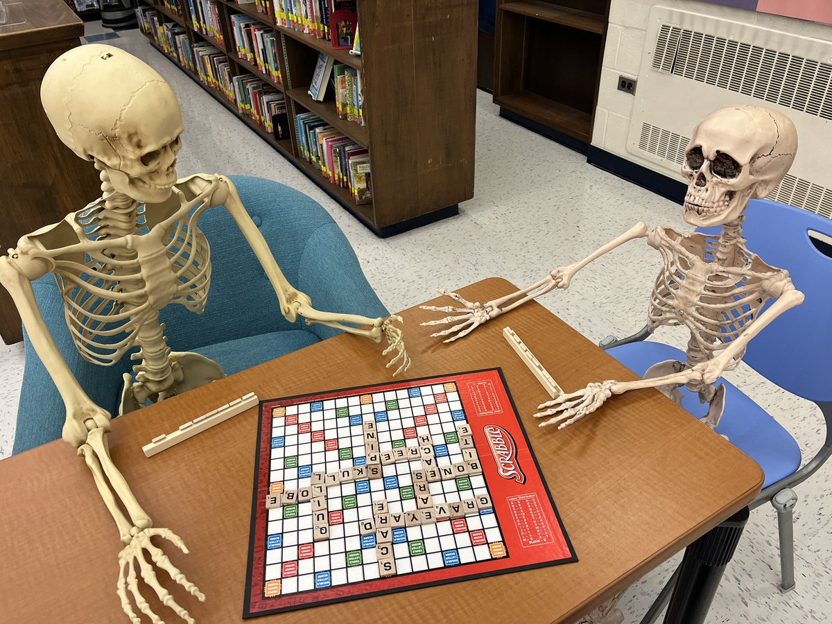 LibraryMESMS's tweet image. Indiana Bones welcomes our new skeleton, Albert Spinestein, to the MESMS Library with an exciting game of Scrabble! @MESMSHorowitz