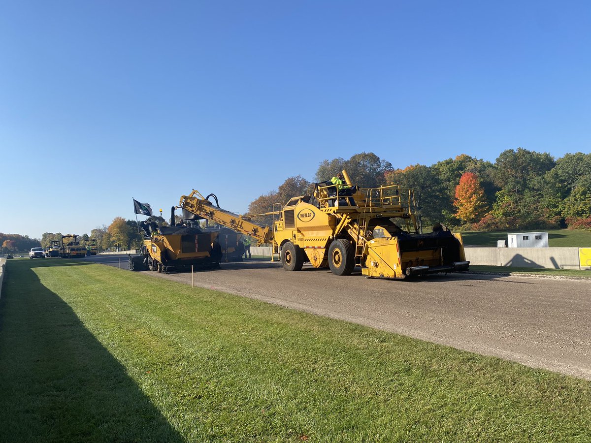 EquipmentToday's tweet photo. Beautiful fall a.m. for #repaving at Elkhart Lake’s iconic @roadamerica. Thank you for showing us around, #RoadAmerica &amp; for an amazing setting as these machines, companies &amp; people work hard to repave the track. @Walbecgroup #elkhartlake #catyellow @AsphaltContrctr @PavementMag https://t.co/bcGAIfA1j7