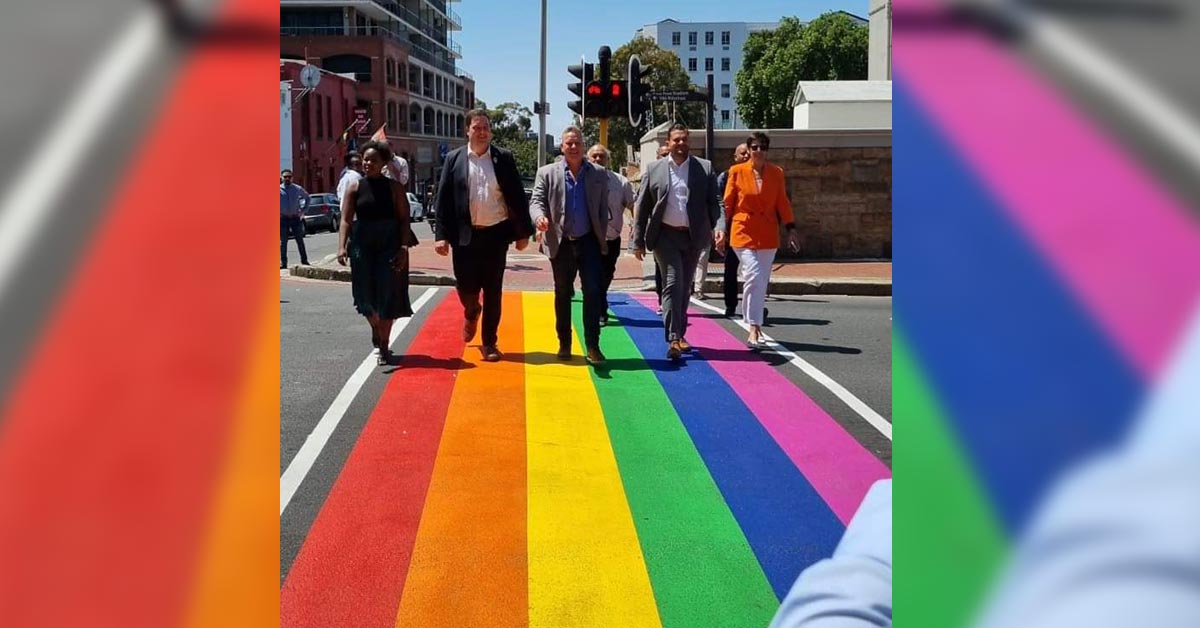 WhileECoyote's tweet photo. Cape Town is now the proud host of a pedestrian crossing in rainbow colors, for the LGBTQIA+ community. The crossing is also supplemented with a pink strip painted on the sidewalks which serves as a Pink Route to guide visitors through this iconic LGBTQIA+ neighbourhood &amp; beyond. https://t.co/J6SodXVNJC