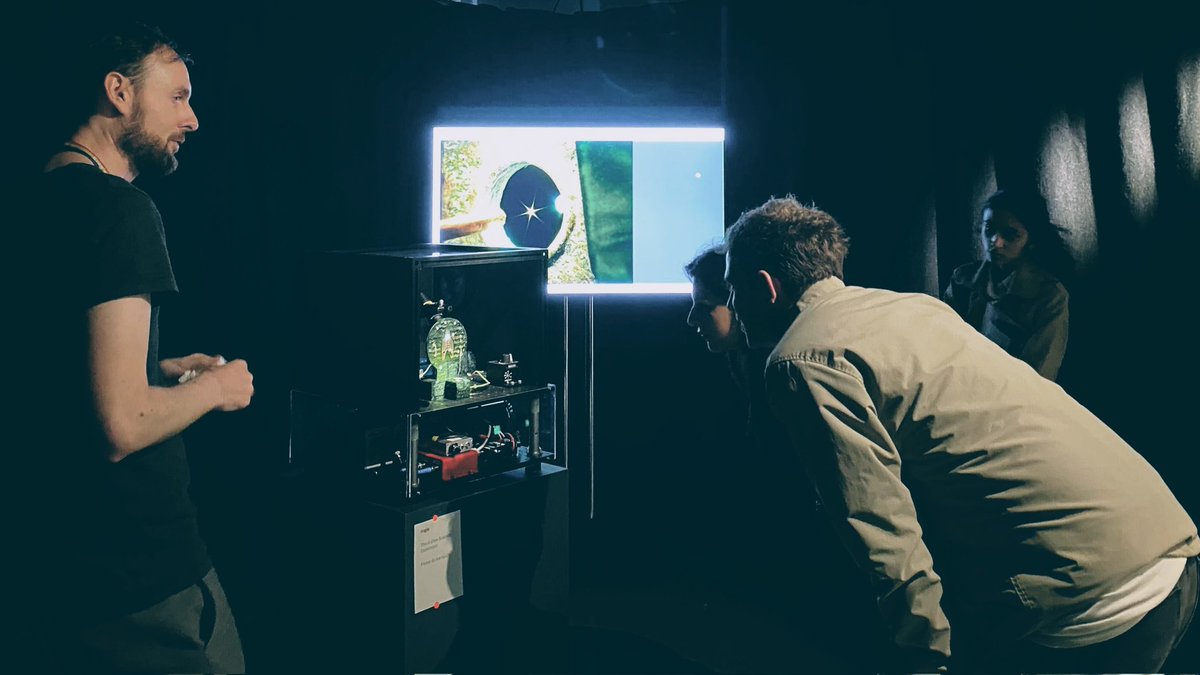 QuantumWorkshop's tweet photo. Moody shot of me explaining how that incredibly diamond-shaped diamond is levitating. #TestingGround at the @SciGalleryLon, work by @KCL_Physics , @KingsNMES https://t.co/yJWR7XXZn2