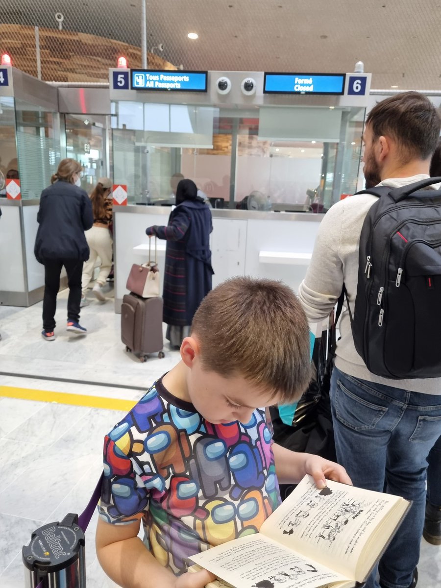 TaraAscroft's tweet photo. Zac at Charles de Gaulle Passport Contol making the snaking queue a little bit more bearable by reading his book #extremereaders @sunnybankschool @Year3sunnybank https://t.co/jnUkBAiwyC