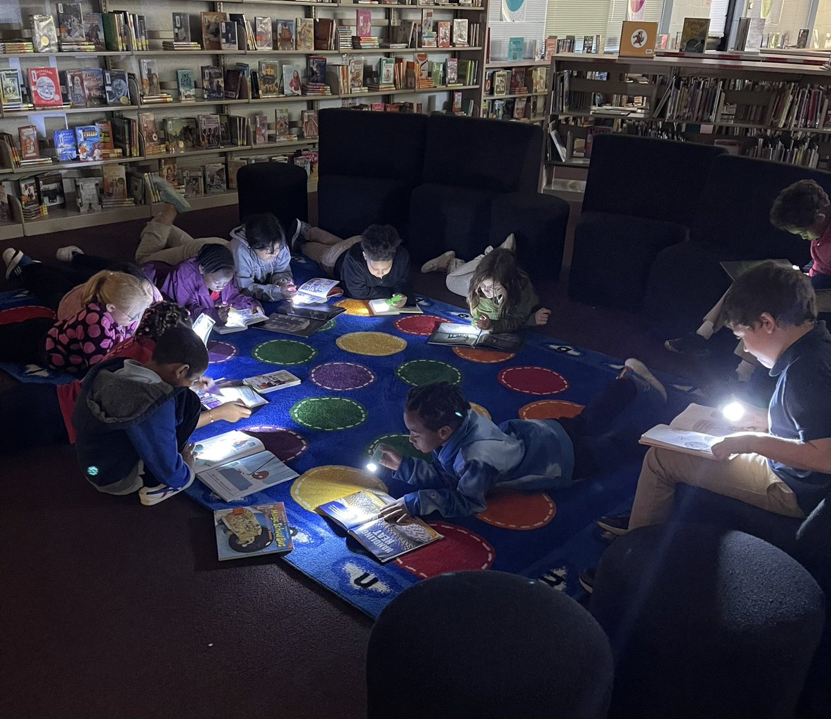 Mrs. Rawls third graders had the best time flashlight reading in library today! 📚