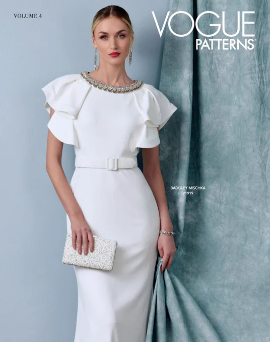 A model poses in a white Badgley Mischka evening dress (Vogue pattern no. 1919) on the cover of the Vogue Patterns lookbook for Winter 2022