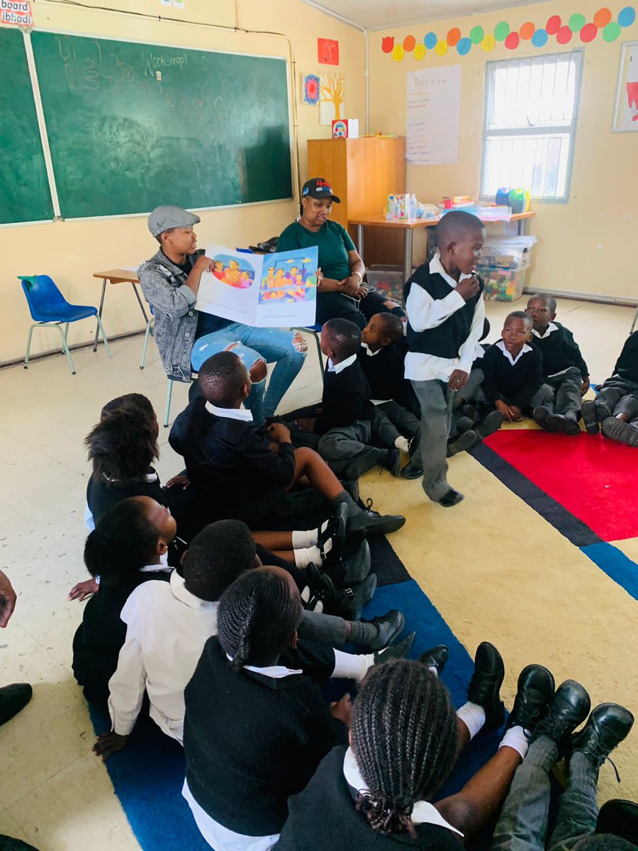 Reading Clubs are where all the fun is; sing  alongs and ice -breakers. Here, Yolanda, Literacy Tutor is  reading a book to grade R learners, followed by questions.