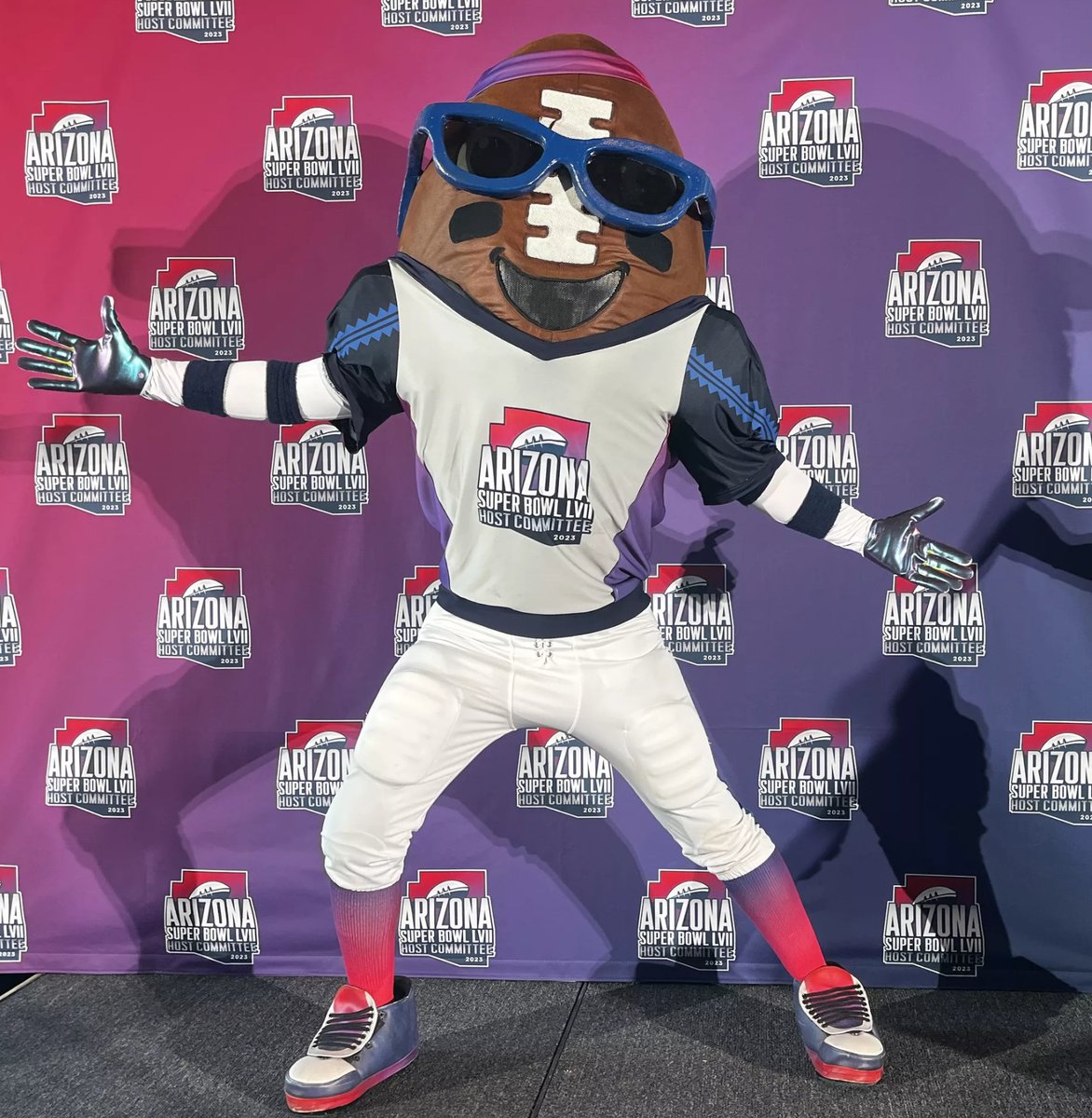 Today I learned that the Arizona Super Bowl Host Committee has its own mascot. This is 'Spike', a sunglasses, eyeblack, and headband-wearing giant smiling anthropomorphic football. (pic via Axios)