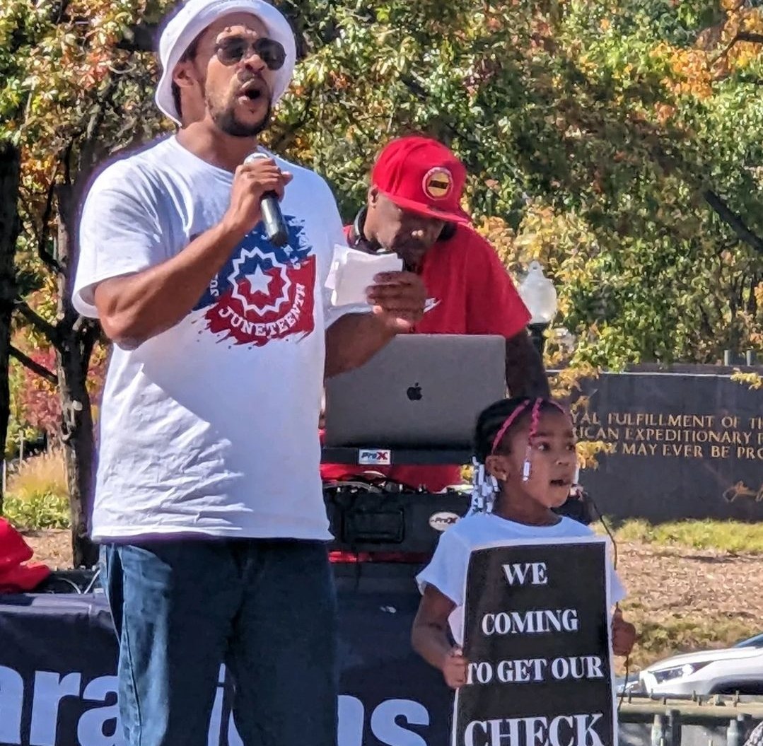 RealNyhiem's tweet photo. This wasn't a struggle march, a gang meeting, an AAA meeting or whatever the opps were saying, this #ReparationsMarch created nostalgic memories for babies that were there. Shout out to @BlaccseedAmeri1 and his daughter and lil man holding that sign, they are our future https://t.co/yflF6VUgO9