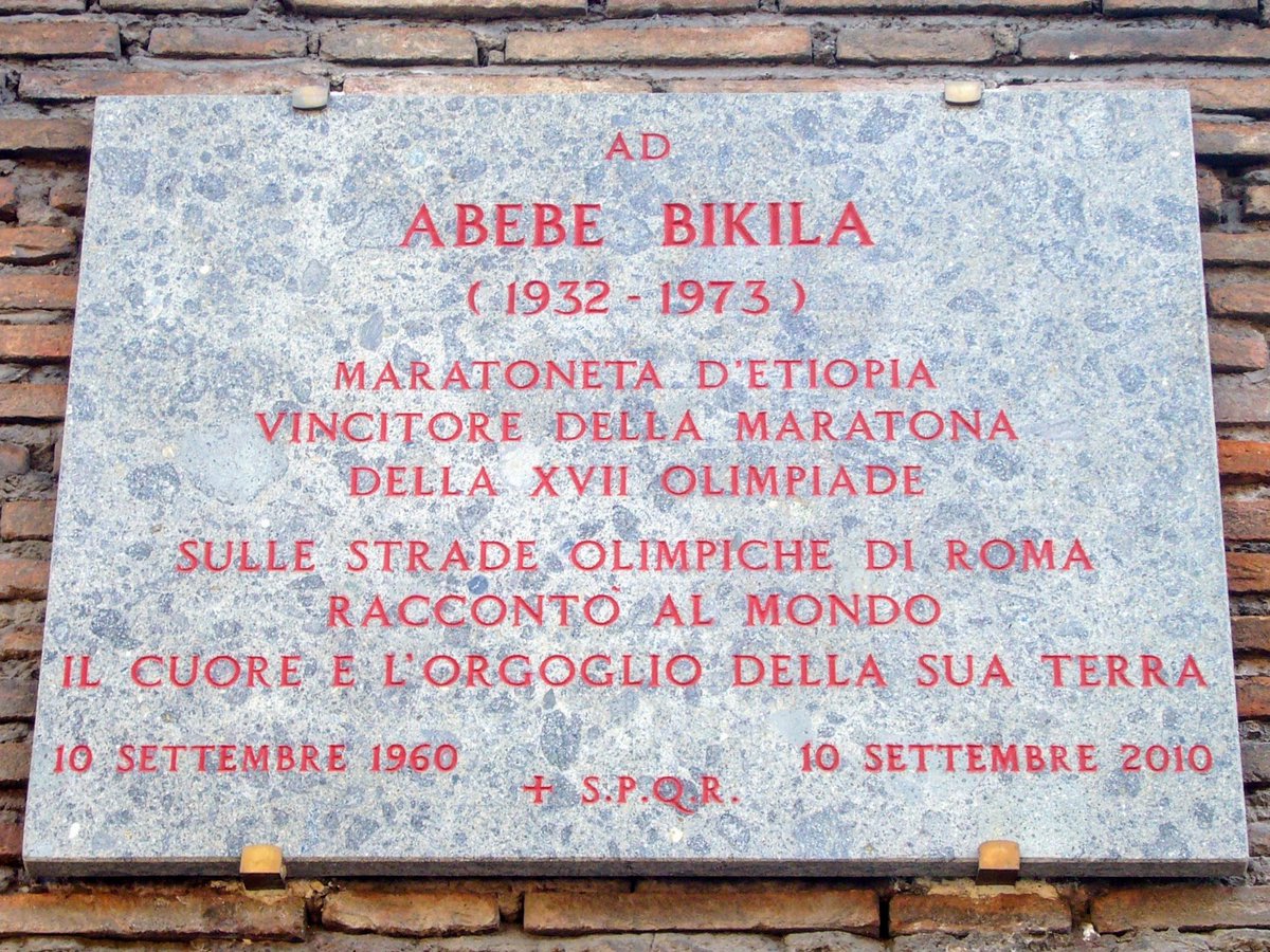 Ethioncamera's tweet photo. @ZmelekotB @jeffpropulsion @mfaethiopia @AbiyAhmedAli @SahleWorkZewde Here is a clear picture. It says; 
  To Abebe Bikila 
( 1932-1973)
Marathoner of Ethiopia
Winner of the Marathon of the 17th Olympic 
On the Olympic streets of Rome told the world
The heart and pride of his land
10 September 1960 ( date of the race) https://t.co/TdABde9Rda