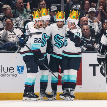Kraken players celebrating after goal with crowns photoshopped on their heads