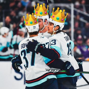 Kraken players celebrating after goal with crowns photoshopped on their heads