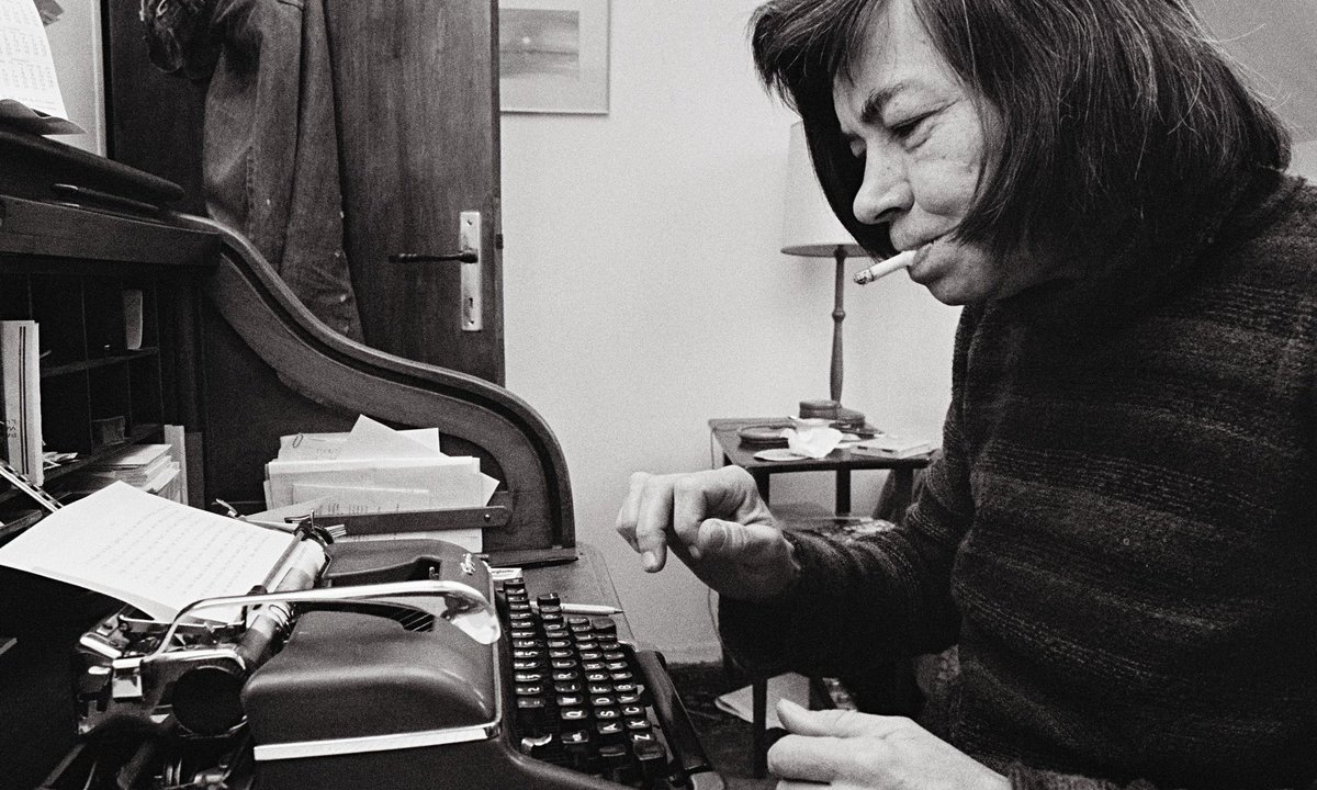 Patricia Highsmith getting after it on the typewriter with a ciggy going.