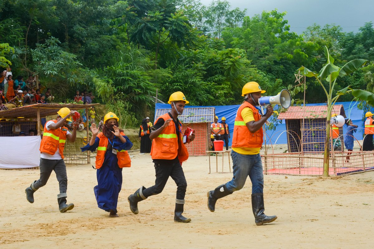 BDRCS1's tweet photo. Cyclone Early Warning and Anticipatory Action drill was organized in Cox's Bazar camps as part of observing #IDDRR_2022 by @BDRCS1 and supported by @ifrc aiming to enhance community awareness about cyclone and sensitize the need of early warning and anticipatory action. https://t.co/vtec8mnOhh