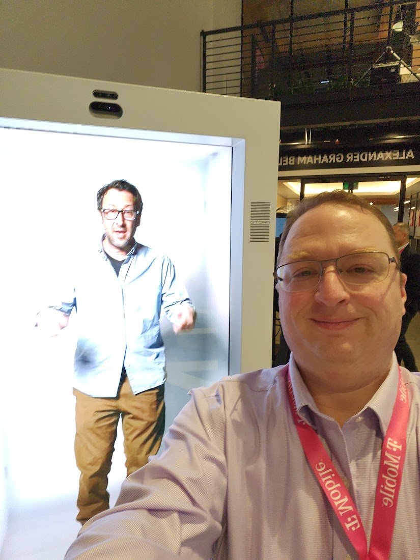 greengart's tweet photo. This man is not trapped in a box, he's transmitting himself as a hologram. @ProtoHologram is not perfect -- it kind of looks like he's a recording -- but it's a fascinating way to add presence way way beyond a Zoom call, and it's real and available today. #TFBAnalystSummit https://t.co/hWcJ2qRrCE
