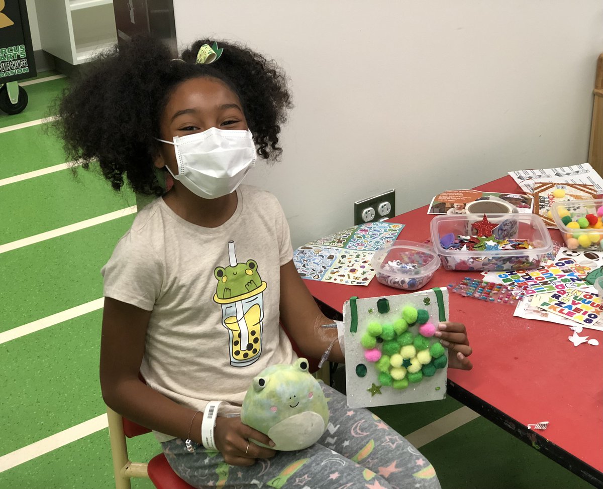 A frog on her shirt, her favorite frog pal coming with her to do art and this artista made a pom pom frog! Frogs all around!