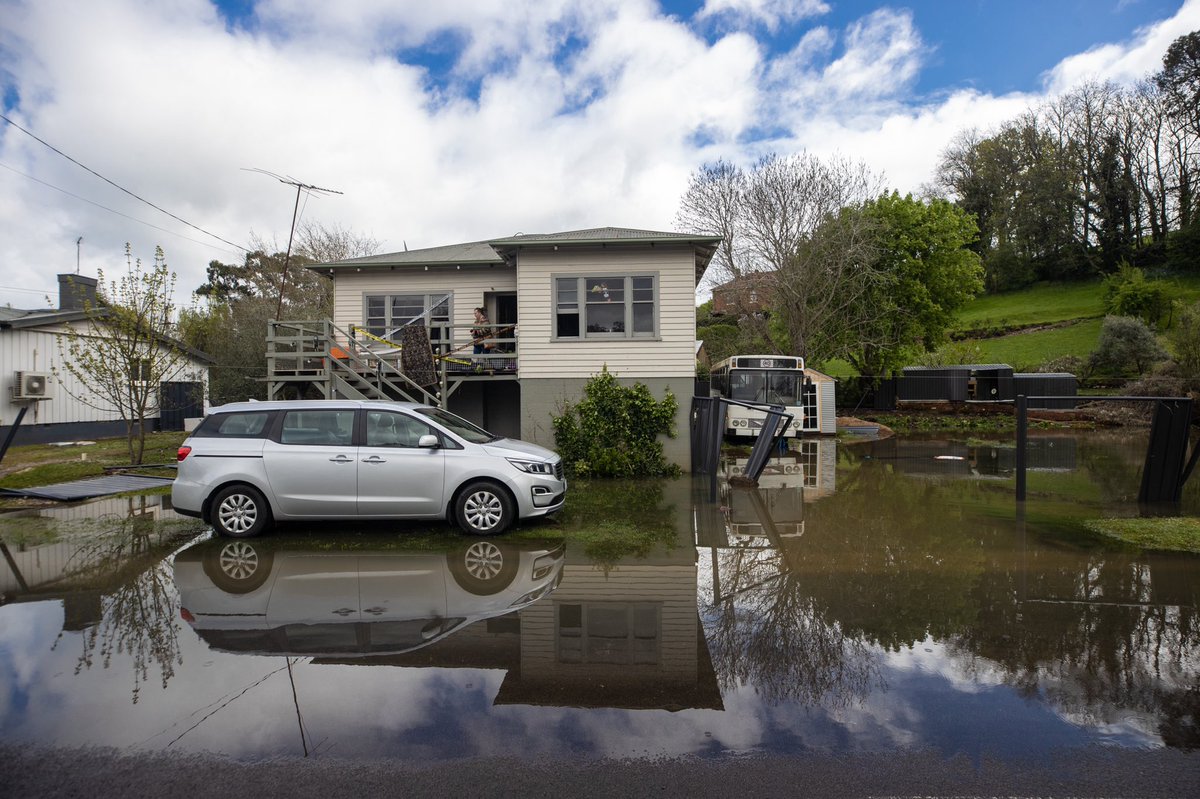 stilllukebowden's tweet photo. Deloraine resident Clinton Hobby surveys the carnage of yesterday’s flood waters. His family’s spa bath sits 200m down the road caught in several trees. #tasweather @abchobart https://t.co/sC8Zvs4loI