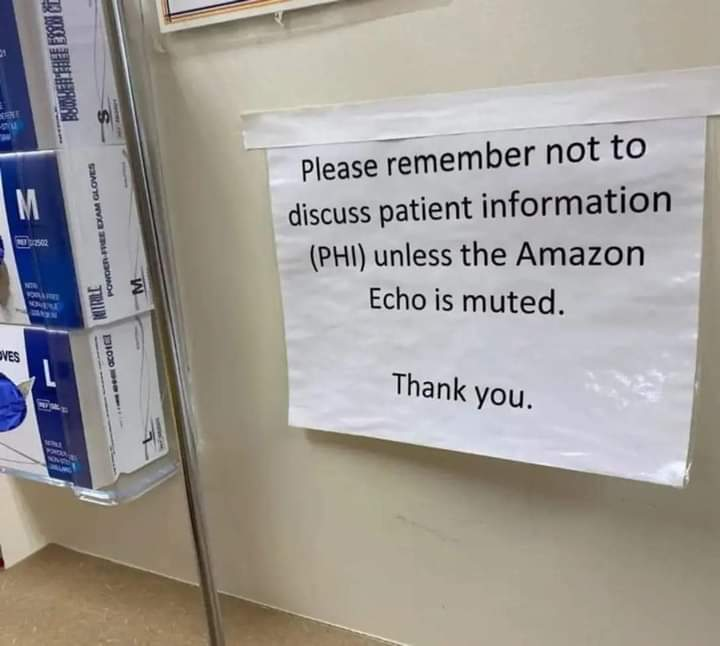 sign taped up in a medical facility that says ”Please remember not to discuss patient information (PHI) unless the Amazon Echo is muted. Thank you.