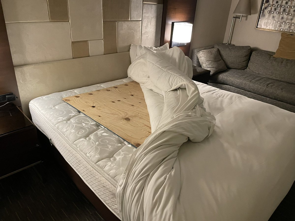 baywater's tweet photo. @HiltonHotels Completely unacceptable!  Checked into hotel in San Francisco and found this under my sheet!  Hit my head and back on it as I fell backwards on bed to lay down. 3/4” plywood under the sheet?  Entire staff in complete shock and didn’t have any clues. https://t.co/aMcZRWngYd