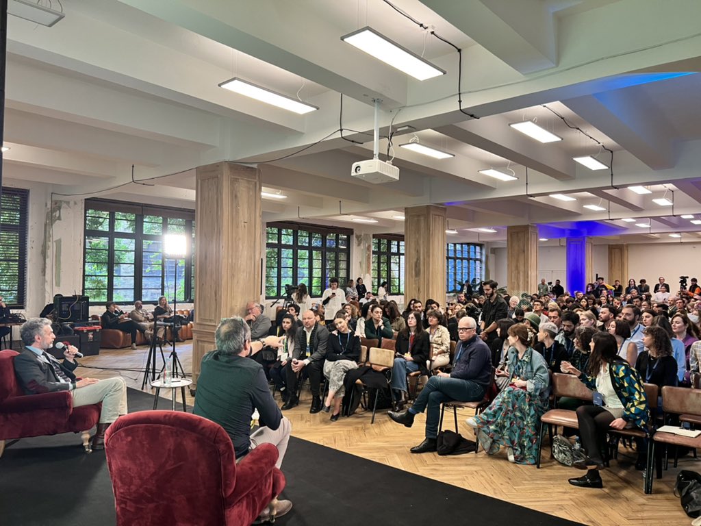 antelava's tweet photo. Things heating up at another packed session at @TbilisiZeg 

“You are the most important country to the Americans until you aren’t,” says @saadmohseni. 

From the audience @tchergo counters: “rhetoric that equates Russia and the US is exactly what Russian propaganda uses” https://t.co/xeFmuekqvr