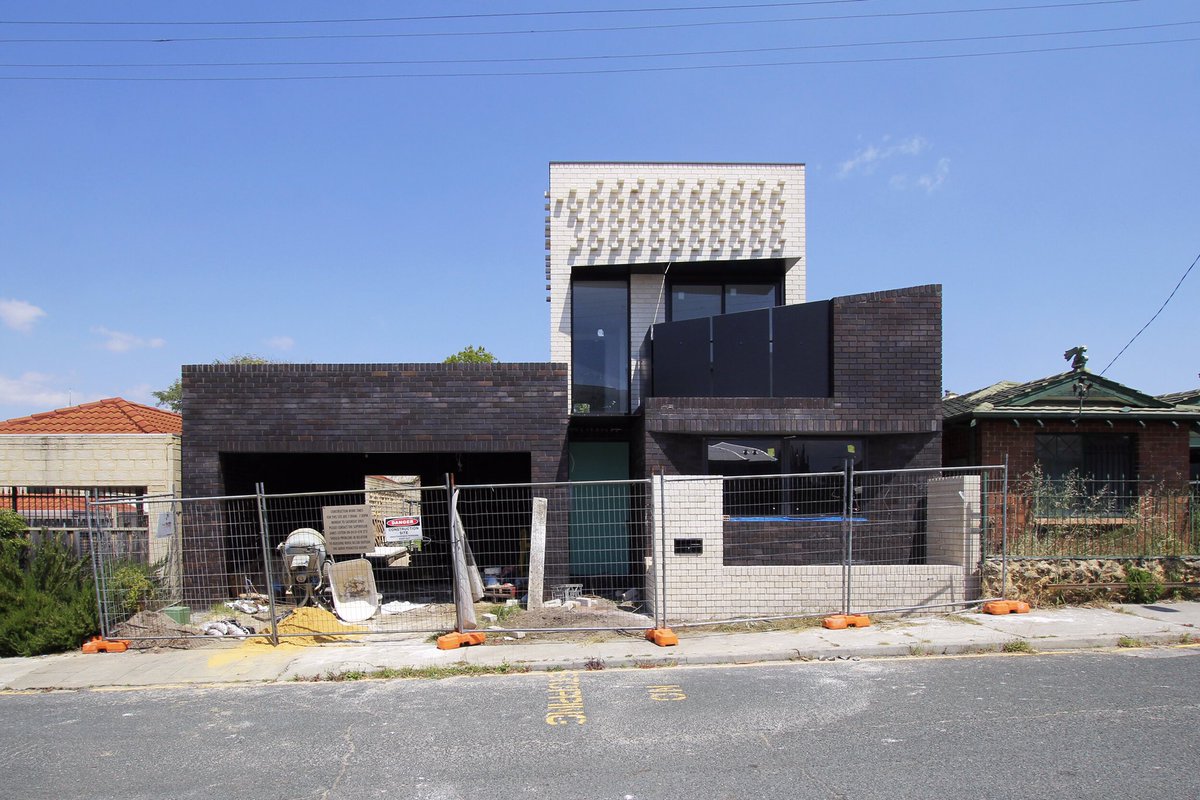 The adornments on our Fitzroy Street project. A black folded aluminum balcony balustrade, entry canopy and white brick planter have been installed on the front facade. The project’s form and materiality establish a somewhat counterpoint, contemporary presence in the streetscape