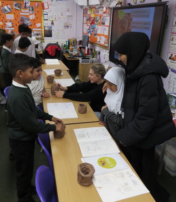 Year 5 held an exhibition to celebrate their Ancient Greek pottery. Families were invited to see the culmination of a 5-week project where every child created their own autobiographical pot. The children have been copying the style of artist Grayson Perry &amp; his coiling technique.