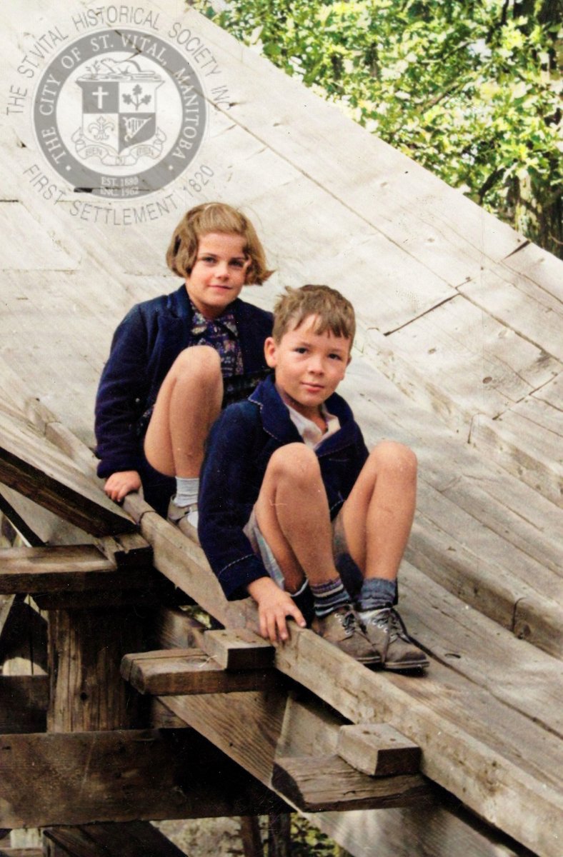 Sheila and Bryan Davies sitting on one of the toboggan slides in St. Vital, late 30's. Bryan lived on Kingston Cres but his family later moved to the intersection of River Rd &amp; Parkville Dr where they had show horses. #stvitalmuseum #stvital #museum #archives #winnipeg #manitoba