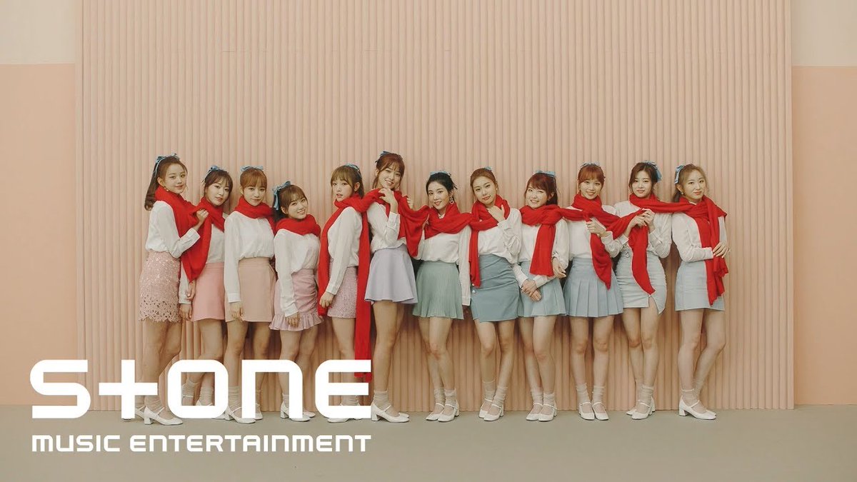 Promotional photo of a Japanese idol girl group posing in a line wearing matching white tops, red scarves, and pastel skirts with 'S+ONE music entertainment' logo.
