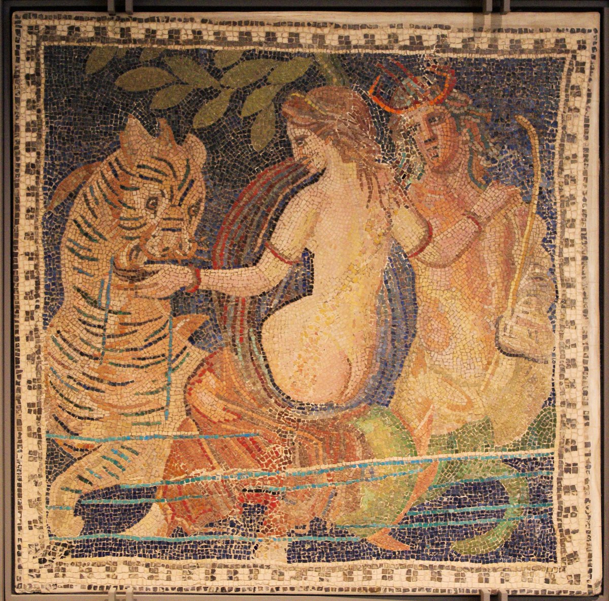 Ancient Roman mosaic of Triton with a Nereid and a Sea Monster (that looks like a Sea Tiger) from the Lyon Musee des Beaux Arts. 2nd Century BC. Photographer: Ken and Nyetta on Flickr via Wikimedia Commons. CCA 2.0.