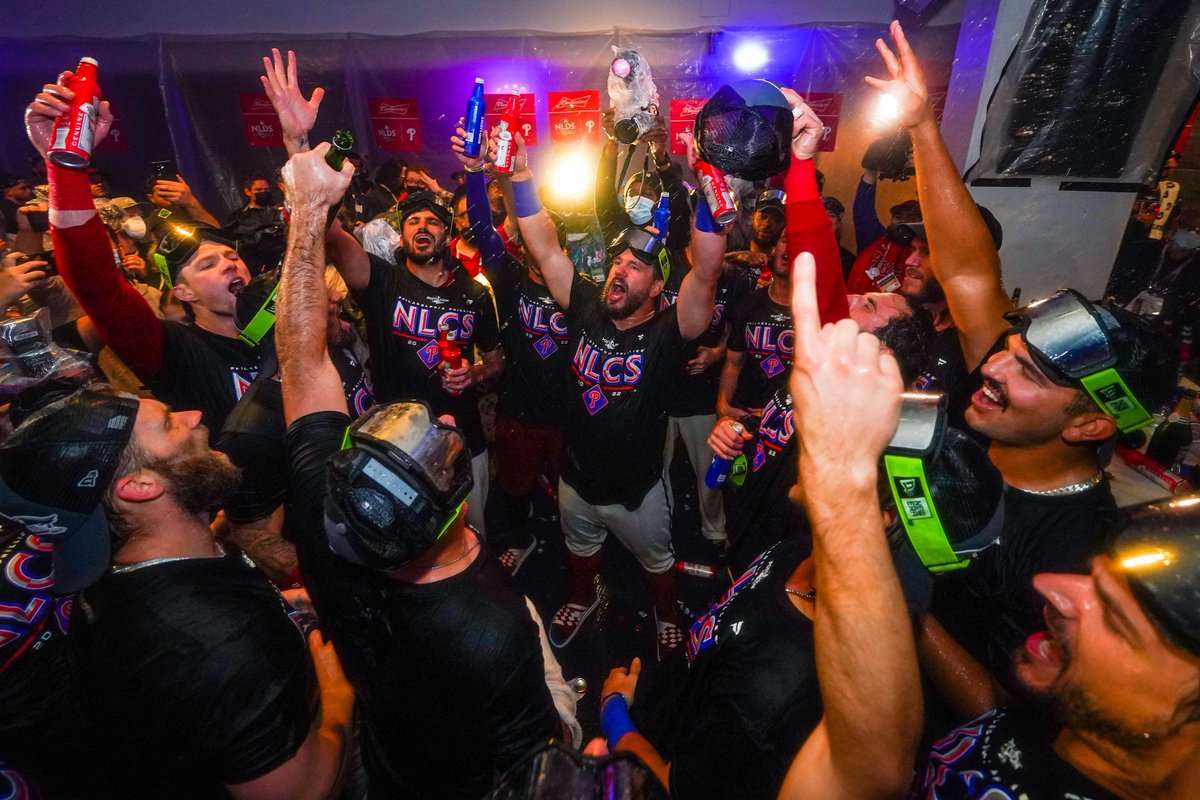 The Phillies singing and dancing in the clubhouse while Dancing On My Own is probably playing. They're wearing NLCS shirts and goggles because they made it to the NLCS. Said.