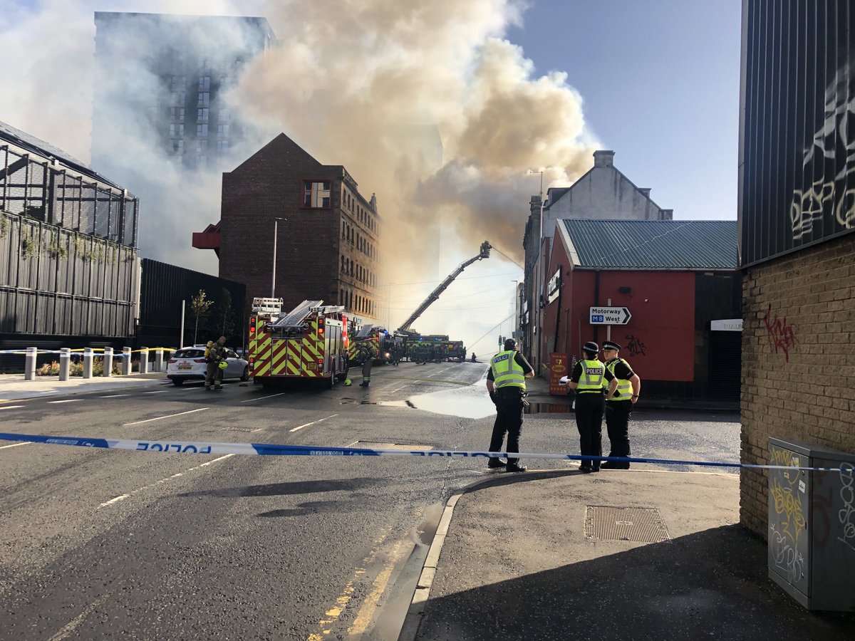 Fire brigade tackling a blaze in the Tradeston area of Glasgow. Smoke is visible over parts of the city