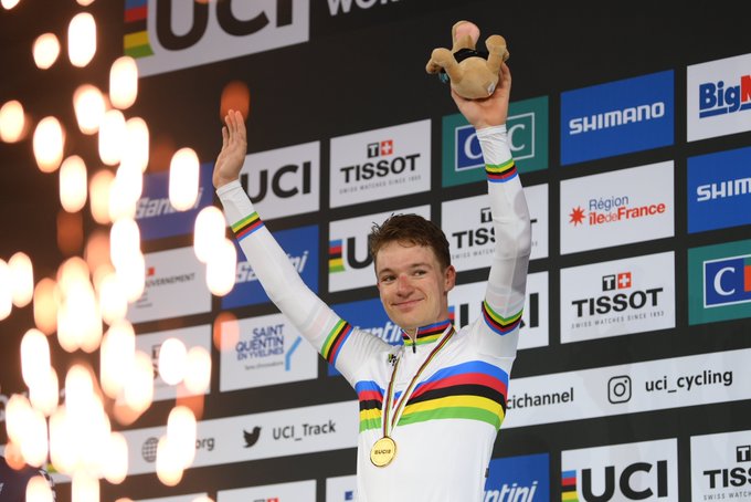 Ethan Hayter acknowledges the crowd on top of the podium