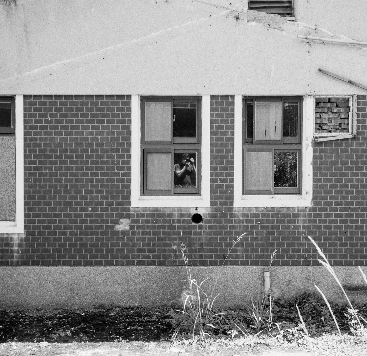 __BrettWilson__'s tweet photo. Self portrait in Window. This building was part of a former American military base in Taiwan which is now a weird mix of ruins and trendy modern restaurants. I believe this building was some kind of officer's quarters.

Ilford FP4 Plus https://t.co/mG2OyTzKs5