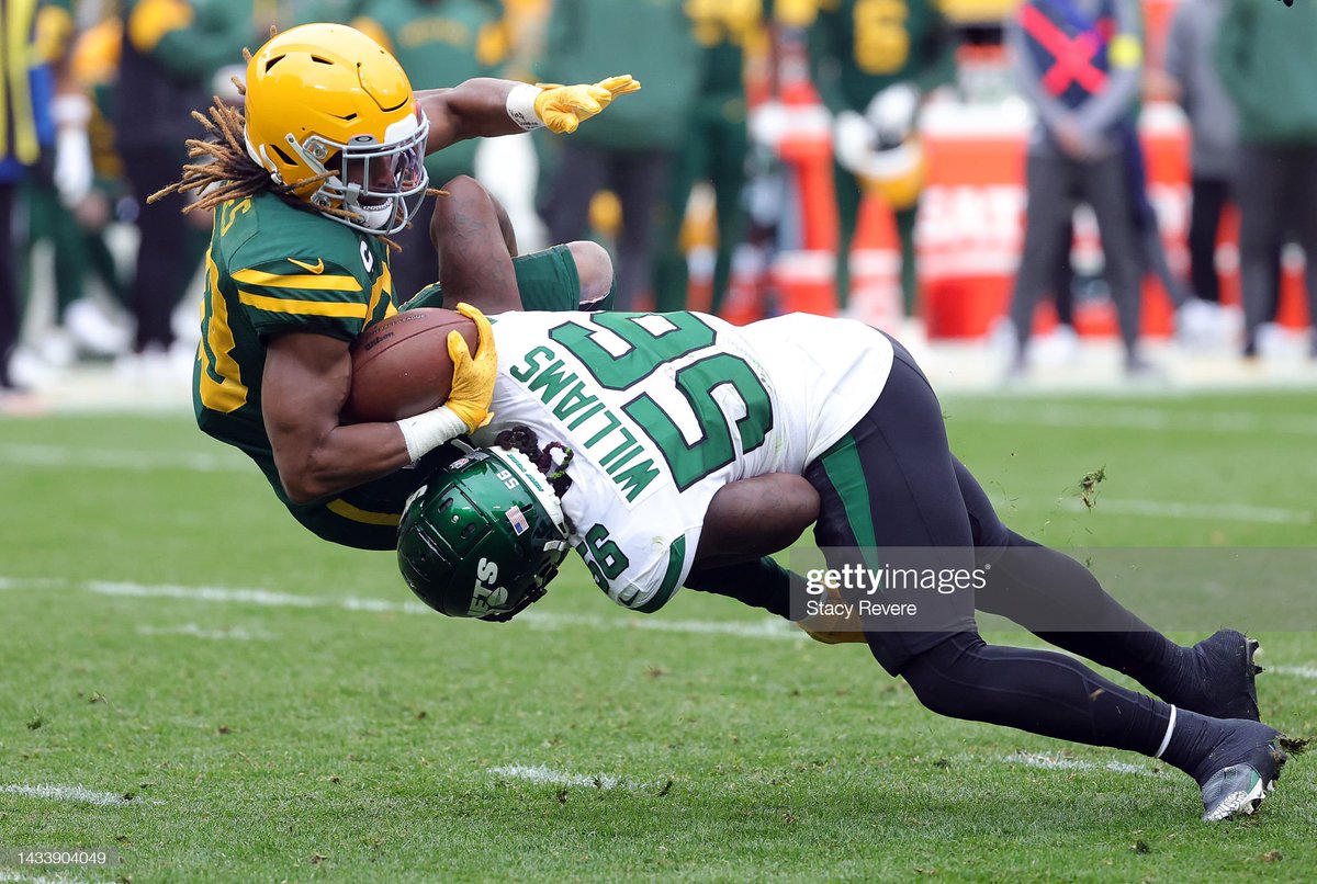 GettySport's tweet image. Aaron Jones #33 of the Green Bay Packers gets tackled by Quincy Williams #56 of the New York Jets in the third quarter of a game at Lambeau Field  📷: Stacy Revere