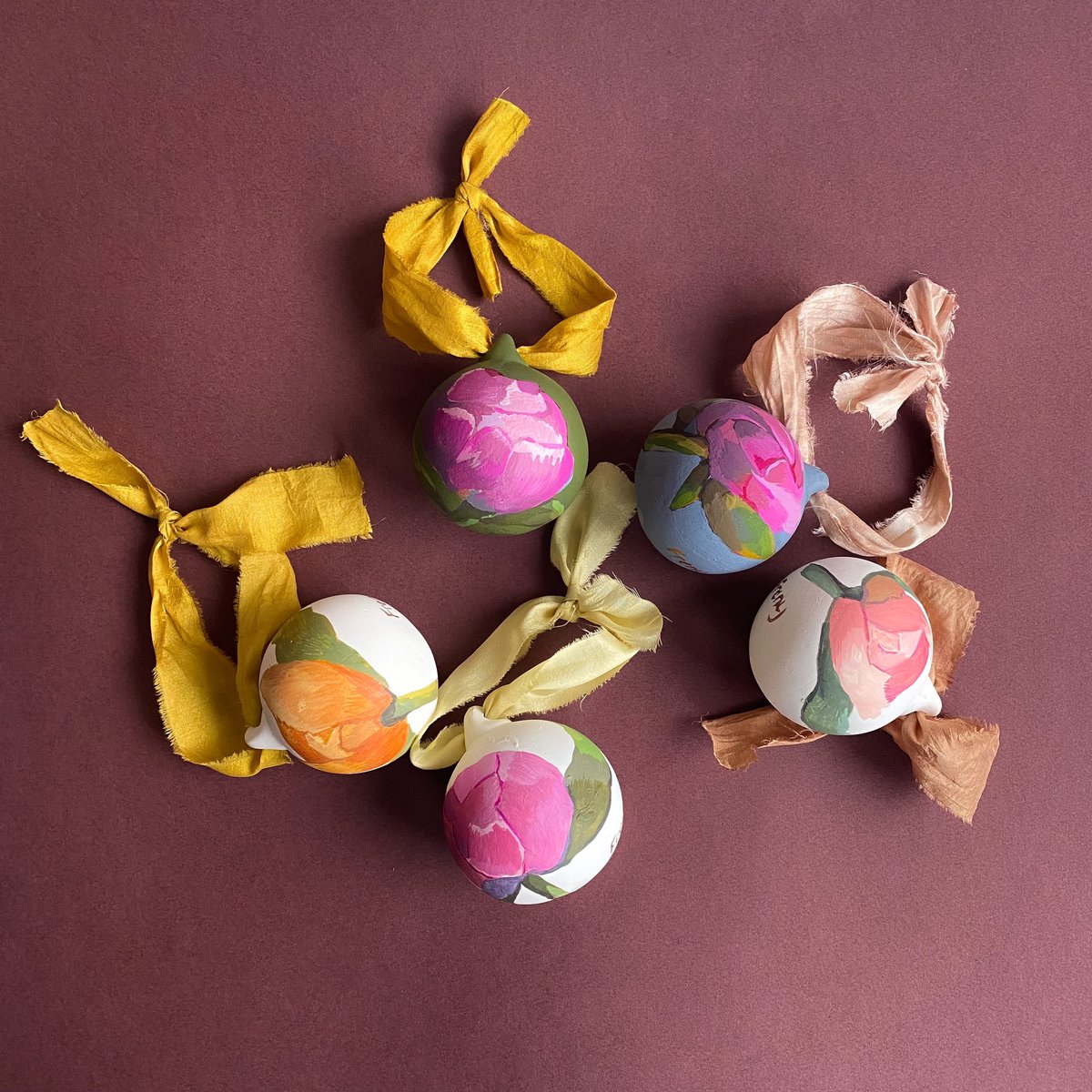 Freny's tweet photo. @mared_gruffydd Hi! I hand paint flowers onto bisque baubles from my studio in north London. They are tied with recycled sari remnants that have been dyed using foraged material from a British creator. My website is https://t.co/yu7MLoRwa4 They are £40 each https://t.co/aAsE8bvXSi