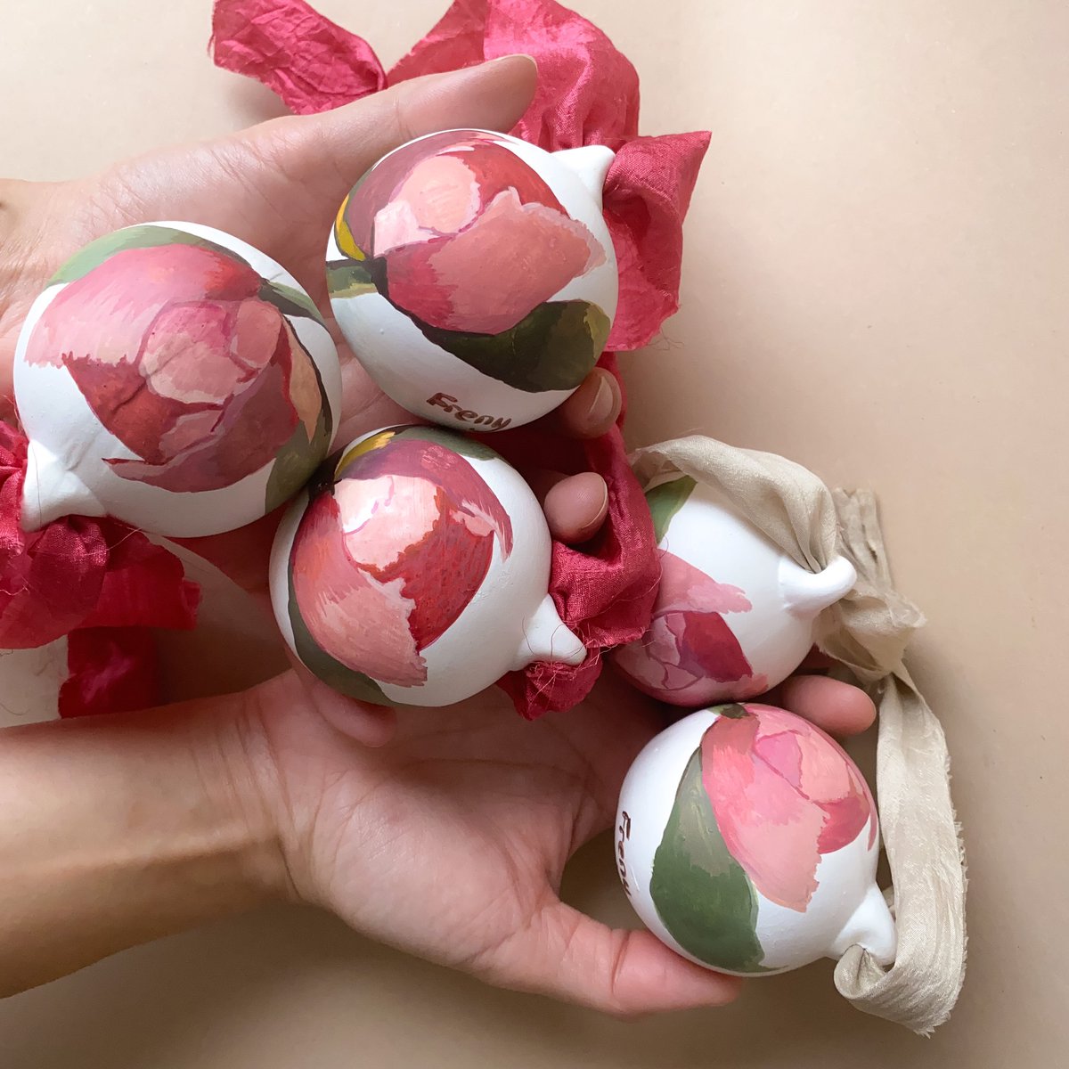 Freny's tweet photo. @mared_gruffydd Hi! I hand paint flowers onto bisque baubles from my studio in north London. They are tied with recycled sari remnants that have been dyed using foraged material from a British creator. My website is https://t.co/yu7MLoRwa4 They are £40 each https://t.co/aAsE8bvXSi