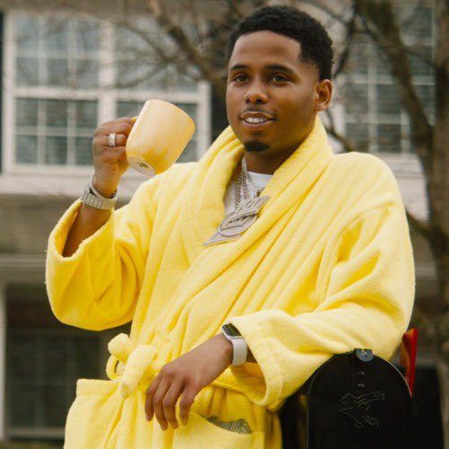 Poo shiesty in a yellow robe relaxing with a yellow mug. Good vibes