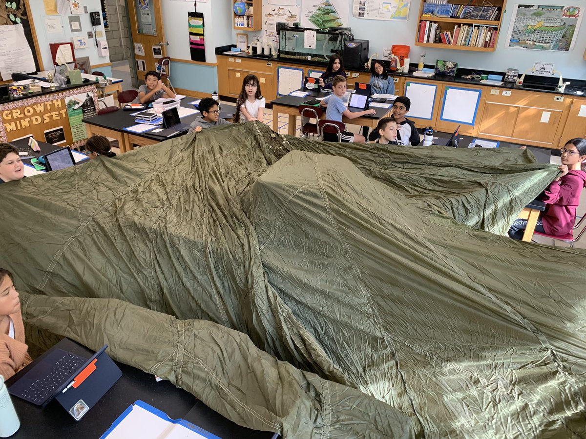 Cooper6Sms's tweet photo. Students were able to make observations of a real parachute canopy used by a member of the military. It was way bigger than we thought! Great inspiration for our end of unit Products of Learning: creating parachutes for eggs! #LATIC #scarsdalemspride https://t.co/ehcespC3hu