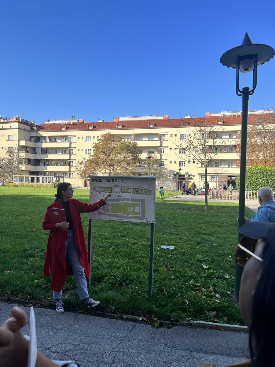 EmilyAssembly's tweet photo. Touring Karl Marx Hof, an enormous public housing complex where you can live if you apply and make less than 3K a month. The lease is -permanent- no matter if your income, and you can switch units. Kindergarten, library, bike storage, parking and gardens included. #WhenInWien https://t.co/psVTtYuGKw