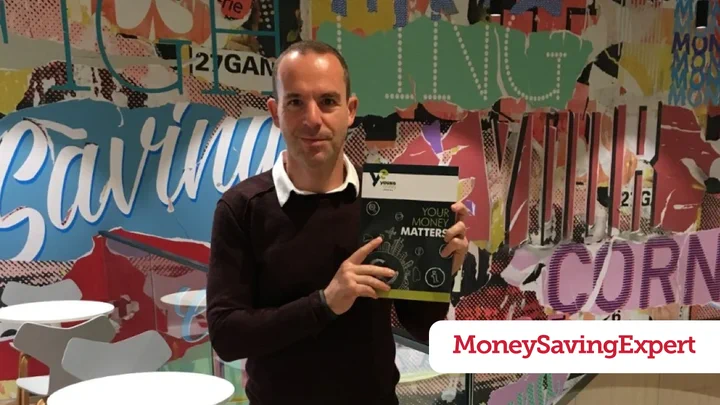 MoneySavingExpert.com founder Martin Lewis holding a copy of the Your Money Matters textbook.