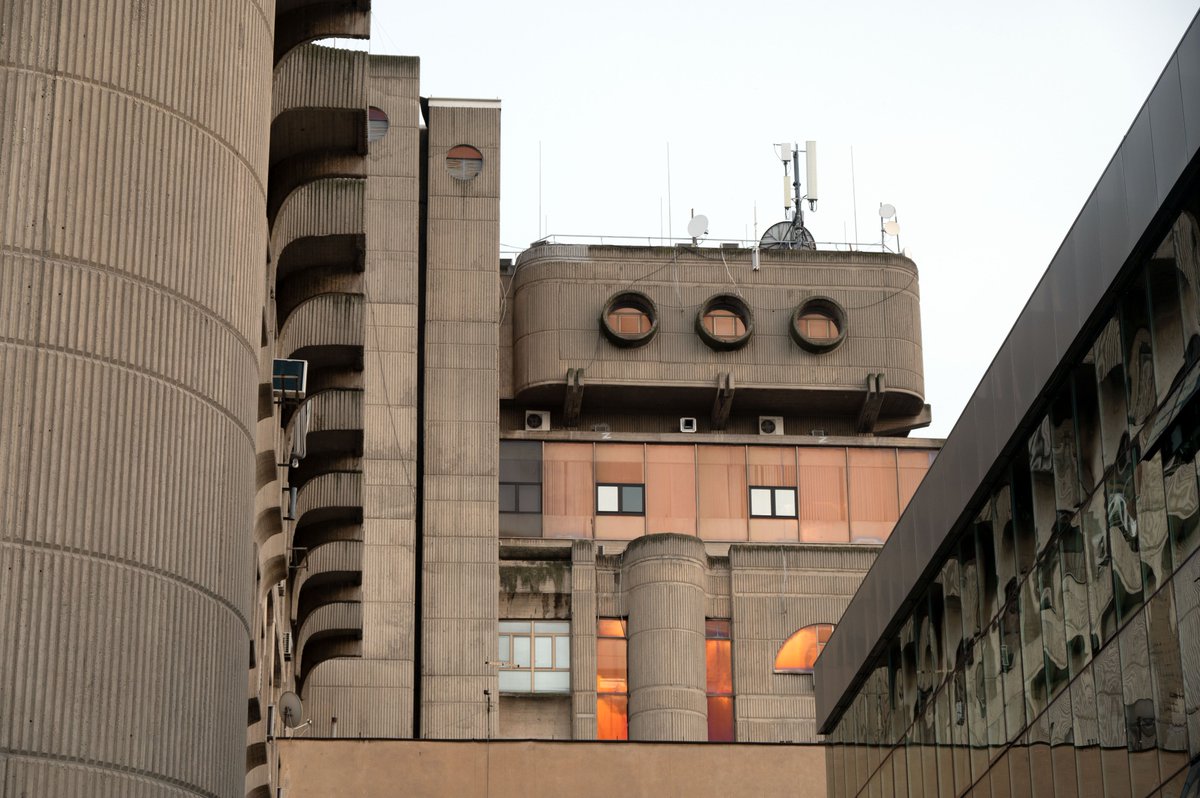 Skopje’s Central Post Office (1974-82) reflects the sunset. Janko Konstantinov’s creative tripartite design is a fantastical blend of rationalist metabolism. A submarine-watchtower-alien encrusted with more recent builds and A/C units adding to a sense of space oddity. 10/12