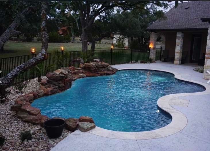 Stunning coping and decking surrounding this lagoon-style custom pool. 
#AustinPoolBuilders #AustinSwimmingPools #ReliantPools