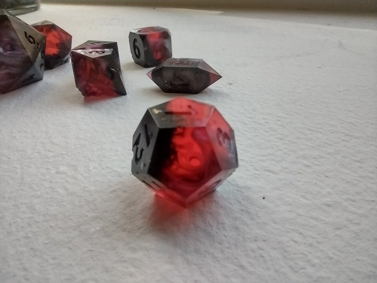 OttersMarket's tweet photo. One of my recent pours. Pretty happy with the colors, but I didn't let the mold release dry and there's bubbles on the faces. 

#dnd #dice #ttrpg https://t.co/qoS7UpqtGk