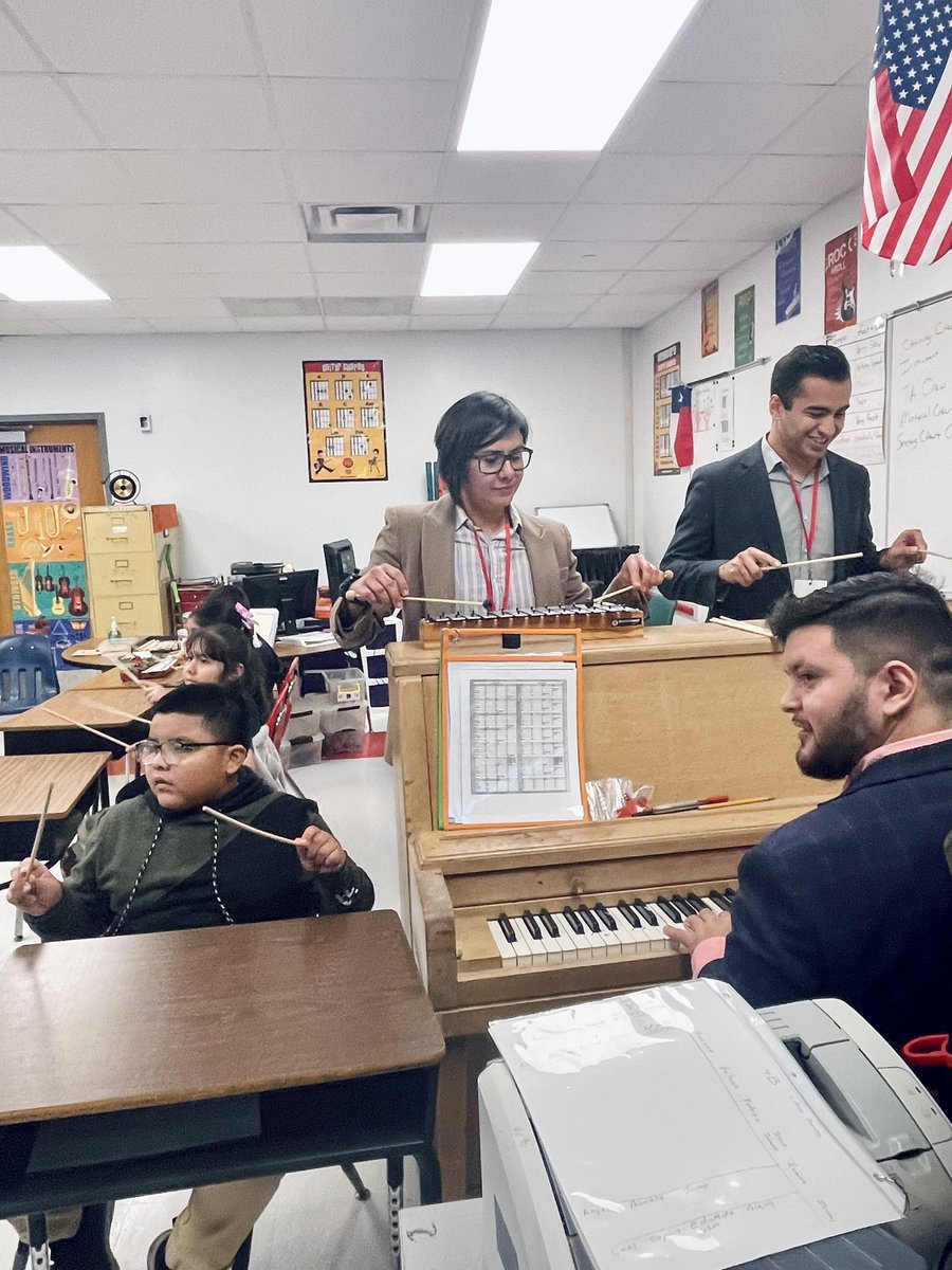 Our Principal of the Day, Jessica Gonzalez, playing musical instruments with the kids.