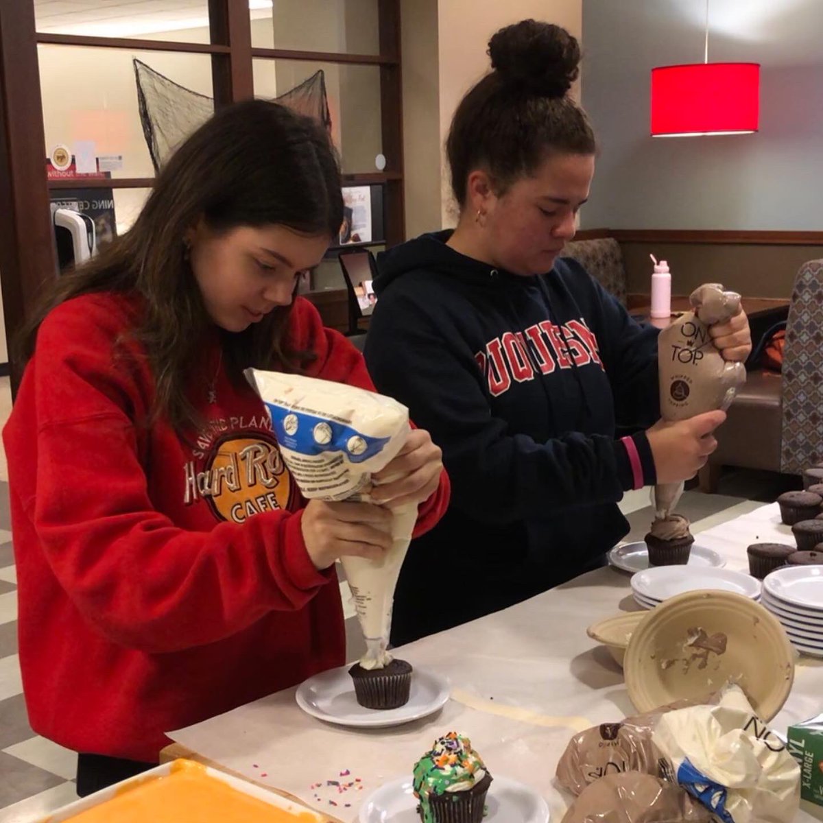 DuquesneDining's tweet photo. We’re having a Spook-tacular time decorating Cupcakes at Hogan! 👻

#duquesneuniversity #duquesne #duqdining #cupcake https://t.co/Kvn1ojHSxv