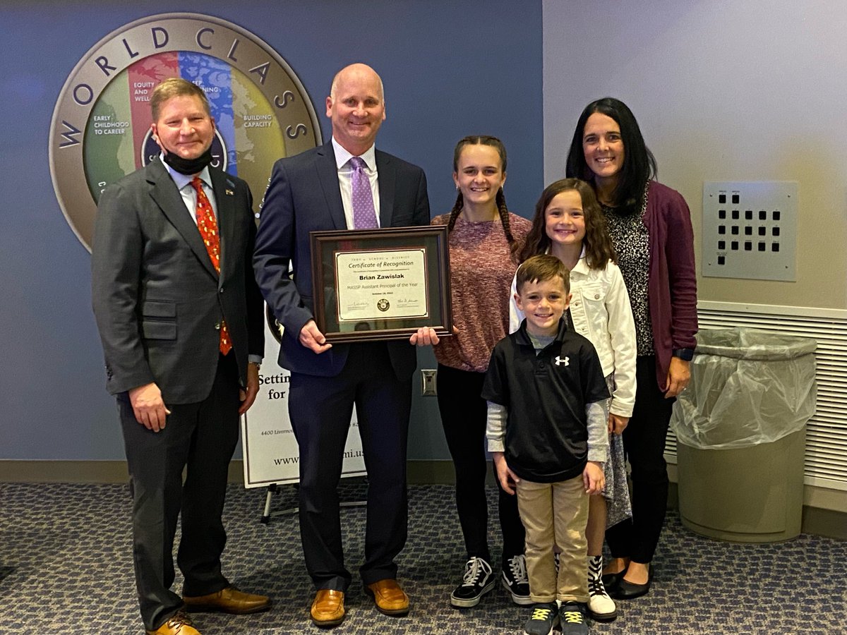 Troy High Assistant Principal Brian Zawislak and his family with Board President Karl Schmidt at the Board meeting tonight recognized as the AP of the year. #gocolts
