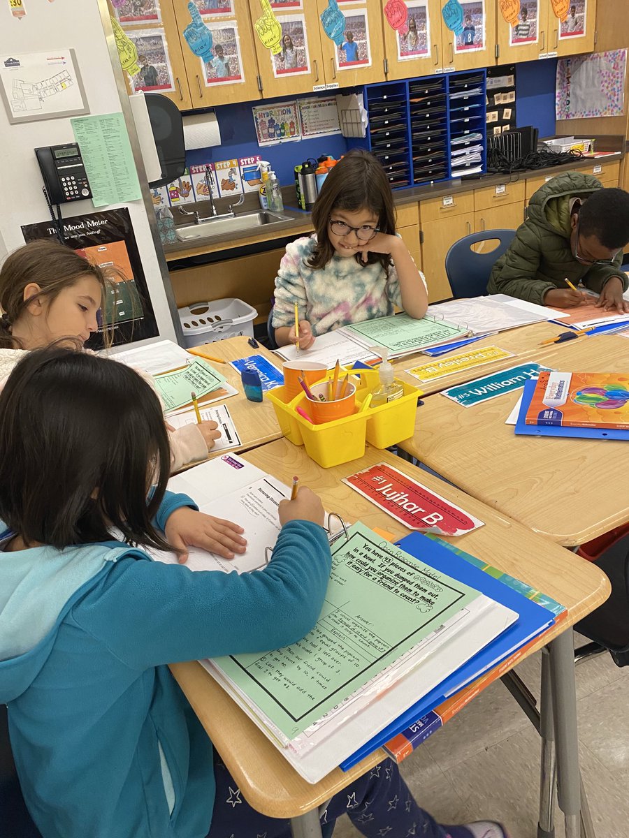 V-O 3rd graders working on an open response division problem and working on organizing their work space on the paper.