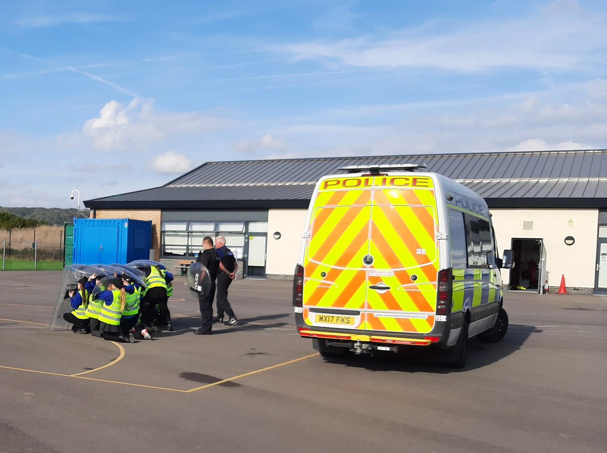 ASPNorthSom's tweet photo. As part of Emergency Services Day, the Worle &amp; Villages NPT attended Haywood Village Academy School to meet the Mini Police recruits. Crew bus and protective shields at the ready, the recruits practiced their 'protective formation' training.

#999Day https://t.co/hcuel0YKEK