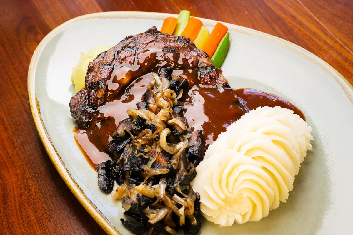 We know how to take comfort food to the next level.  Join us on this rainy Wednesday and enjoy a 12 oz AAA beef rib eye steak fired on the grill as you like it, with whipped potato, seasonal vegetables, fried onion &amp; mushrooms and finished with red wine demi glace.