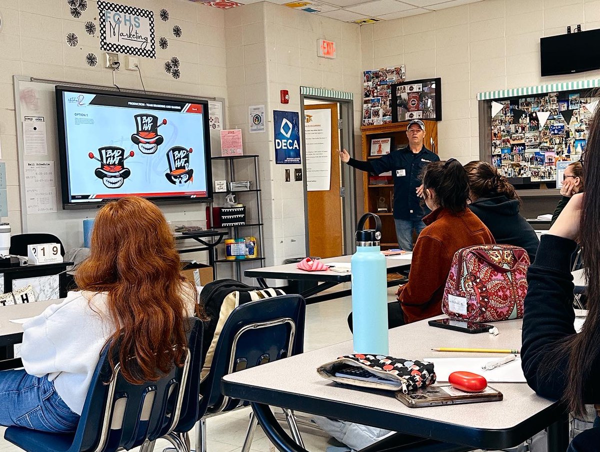 fchsdeca's tweet photo. Today our Promo &amp; Dig. Mktg students had the privilege of listening to @mrood18 from OutdoorFlics. We enjoyed getting to see his work &amp; learn from his experience in graphic design &amp; branding. Thank you for taking the time to come speak to us to us! @FCCollegeCareer https://t.co/P24r3WS0Jk